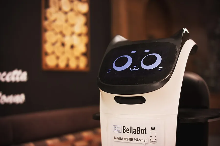 Pudu BellaBot service robot delivering food in a restaurant